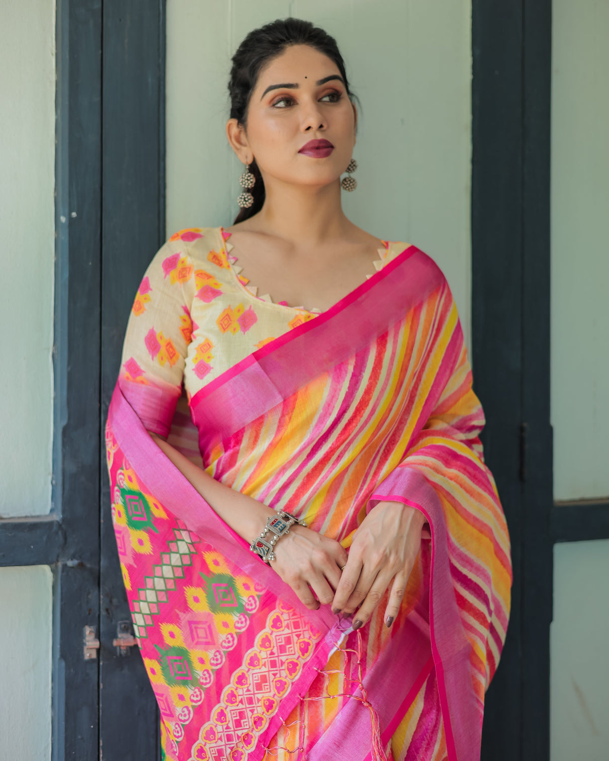 Vibrant yellow and pink ikat printed cotton linen saree with blouse and tassels