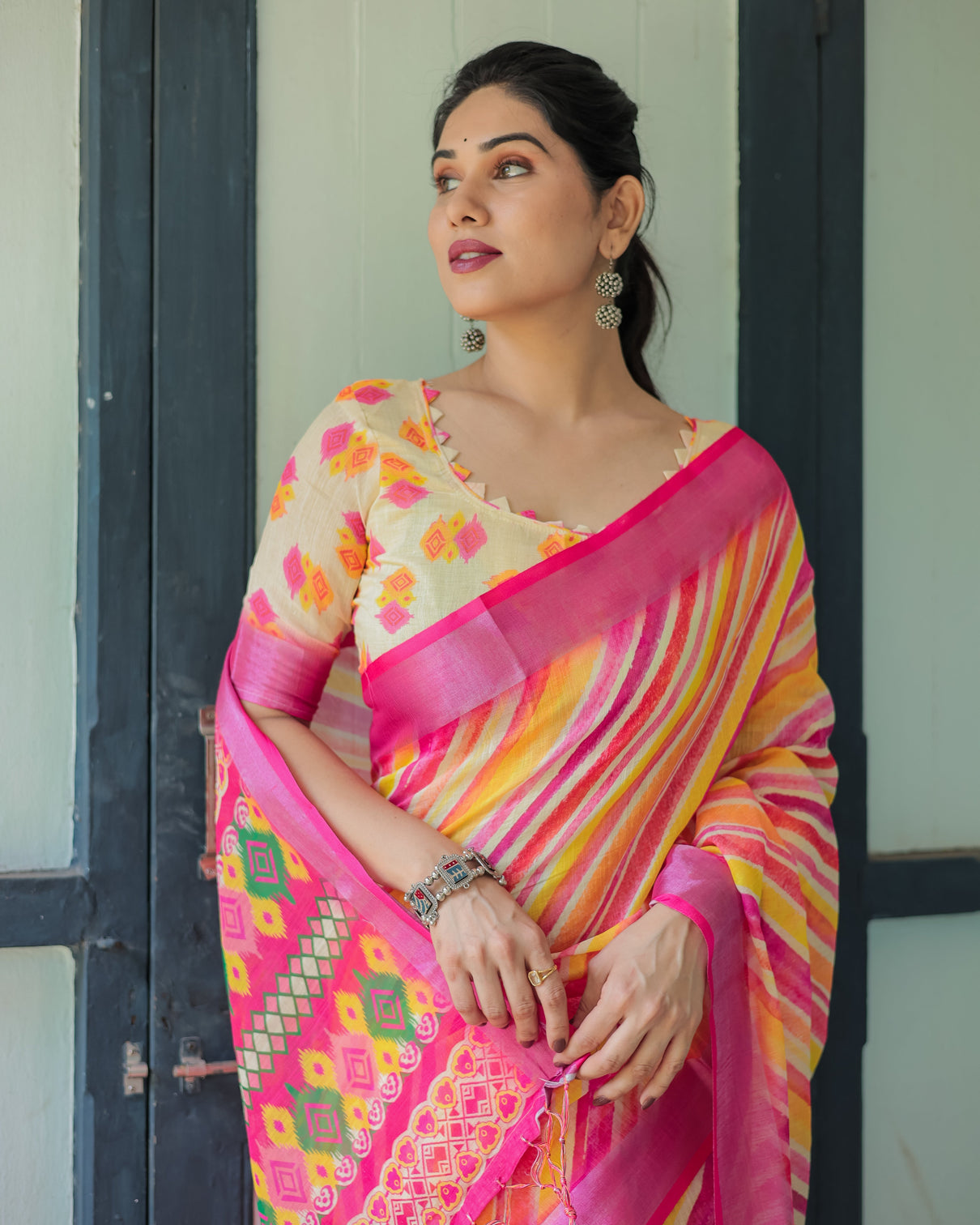 Vibrant yellow and pink ikat printed cotton linen saree with blouse and tassels