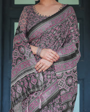 Black pure cotton linen saree with pink striped pallu and tassel accents