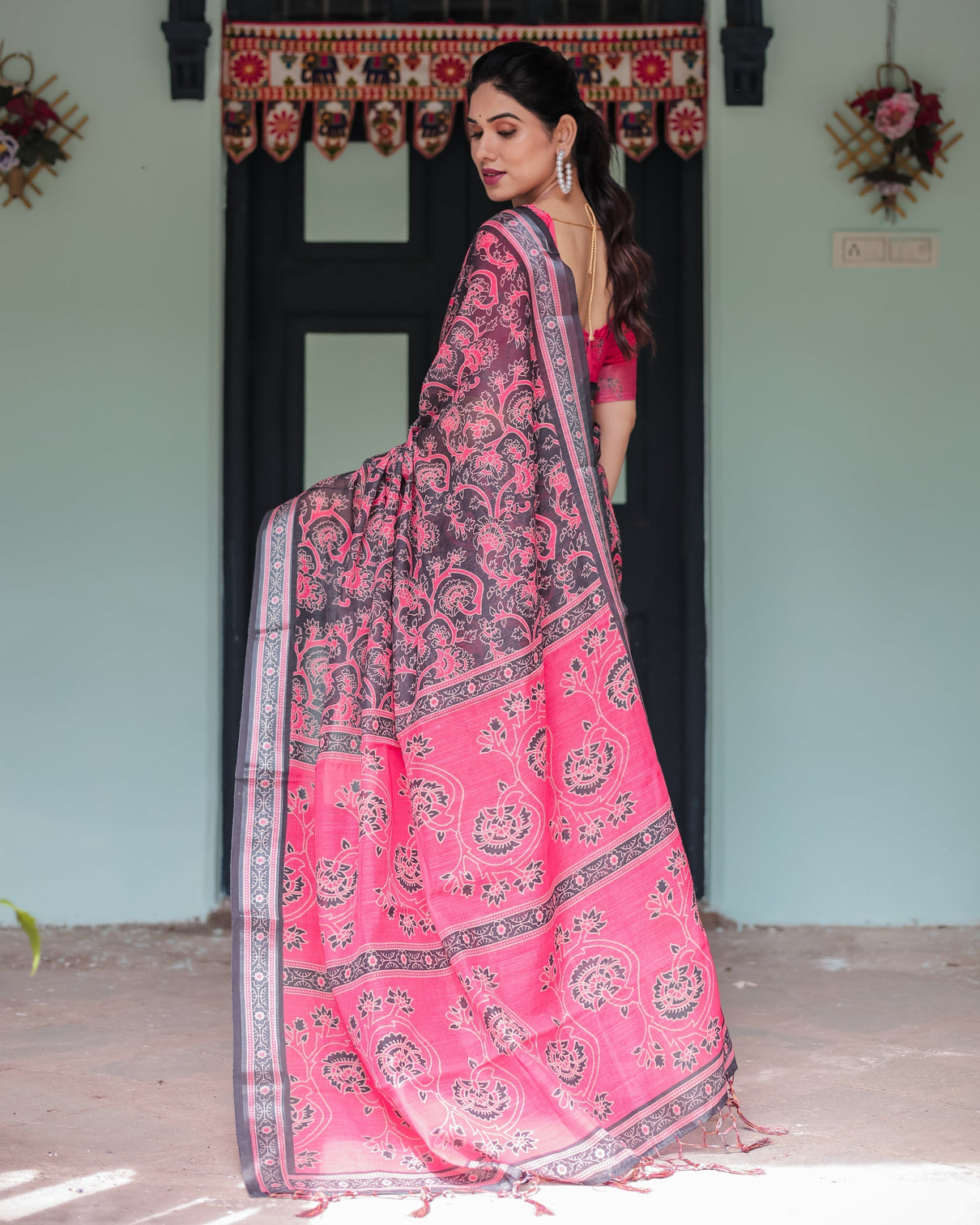 Pure cotton linen saree in black and pink with floral print and tassels