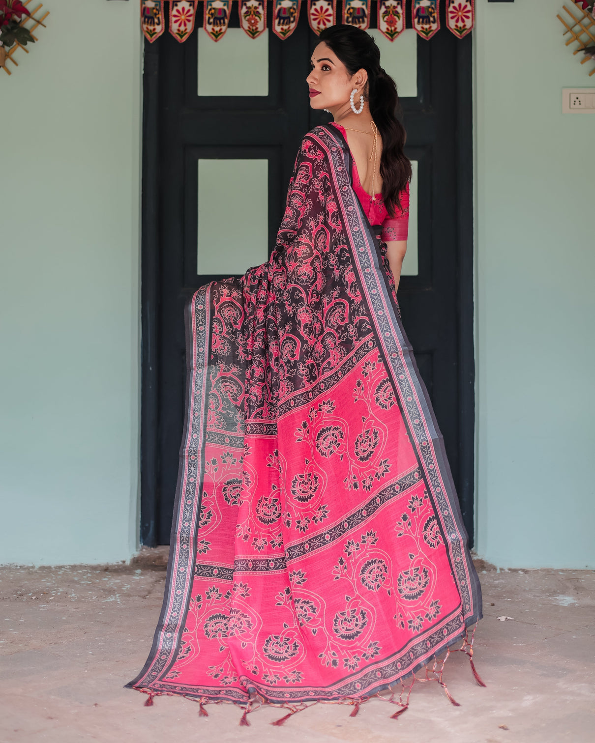 Pure cotton linen saree in black and pink with floral print and tassels