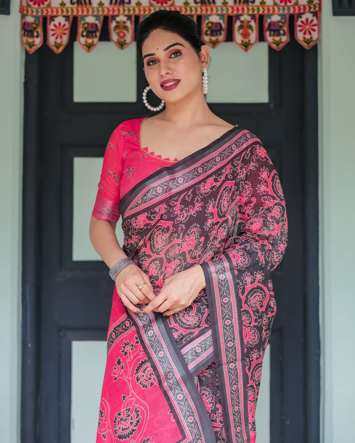 Pure cotton linen saree in black and pink with floral print and tassels