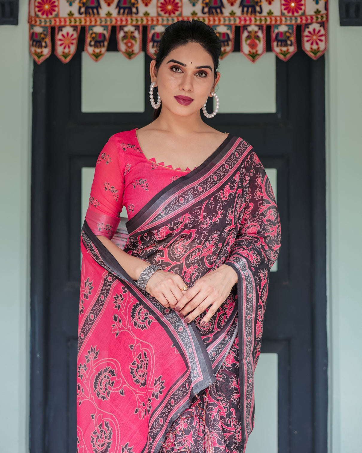 Pure cotton linen saree in black and pink with floral print and tassels