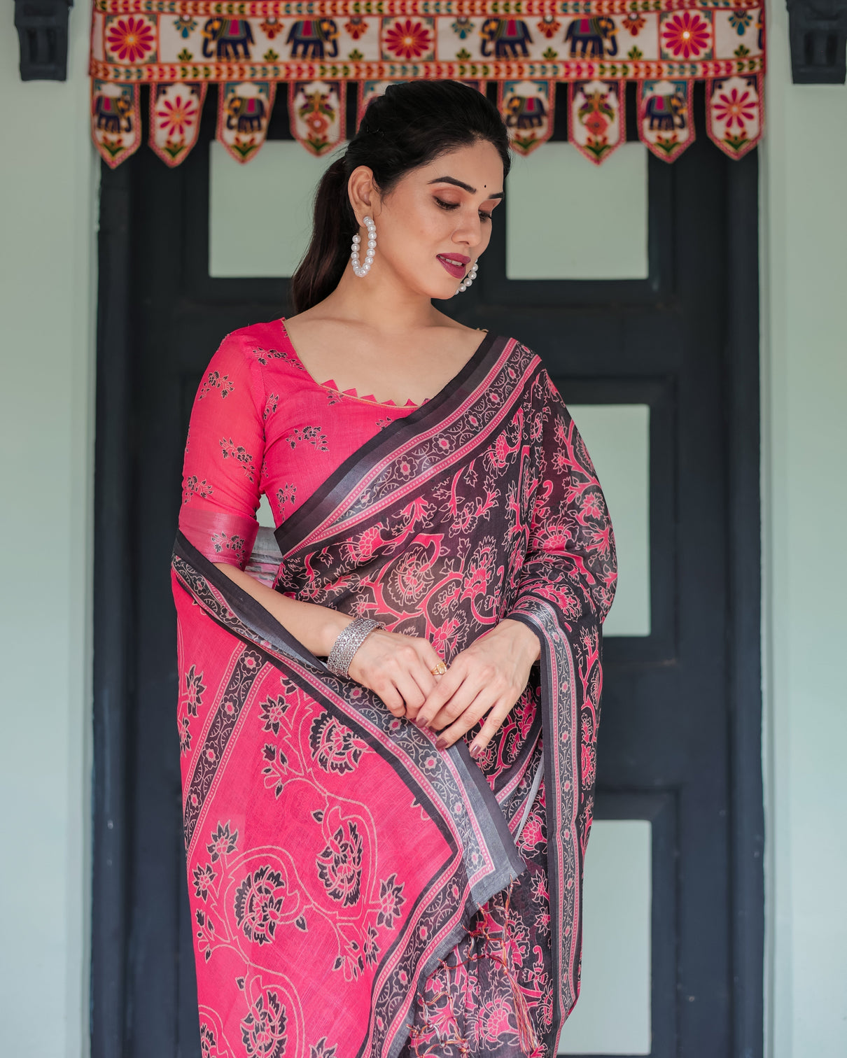 Pure cotton linen saree in black and pink with floral print and tassels