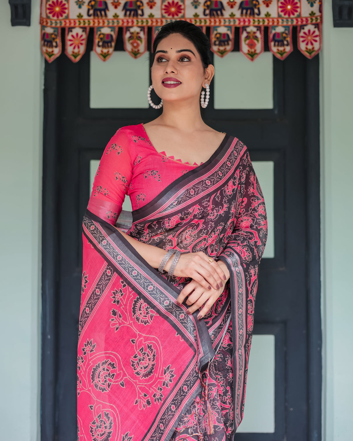 Pure cotton linen saree in black and pink with floral print and tassels