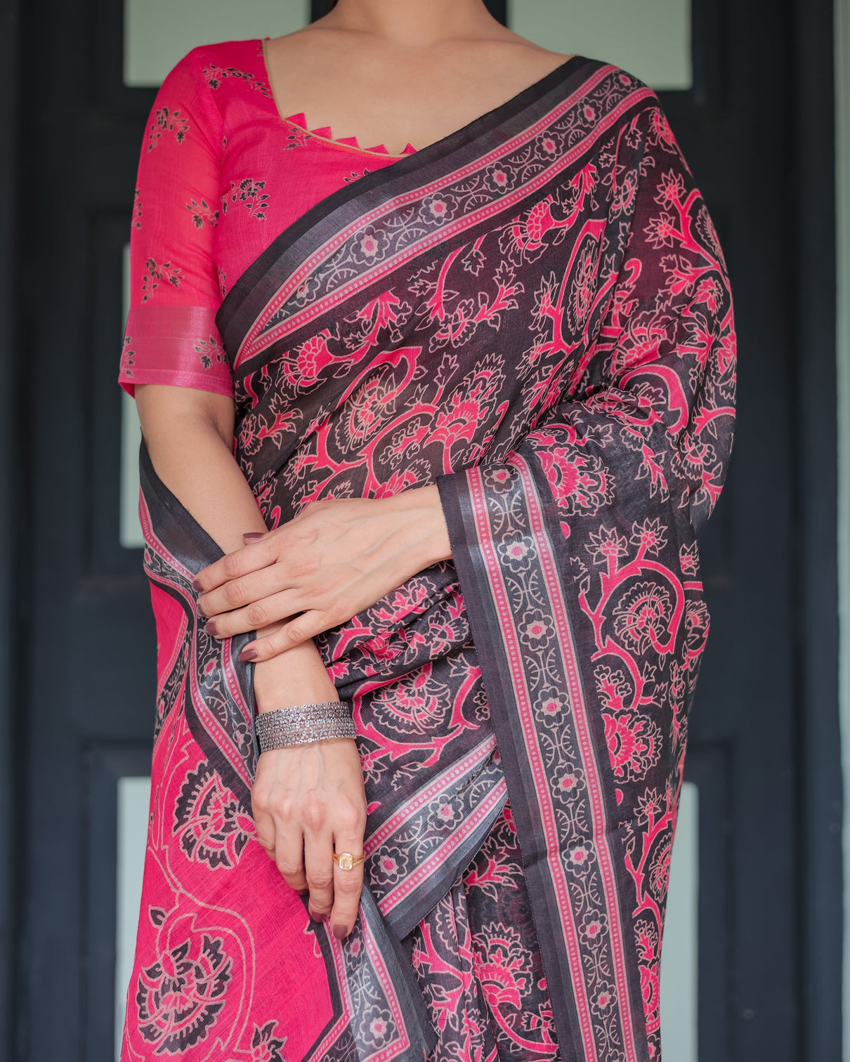 Pure cotton linen saree in black and pink with floral print and tassels