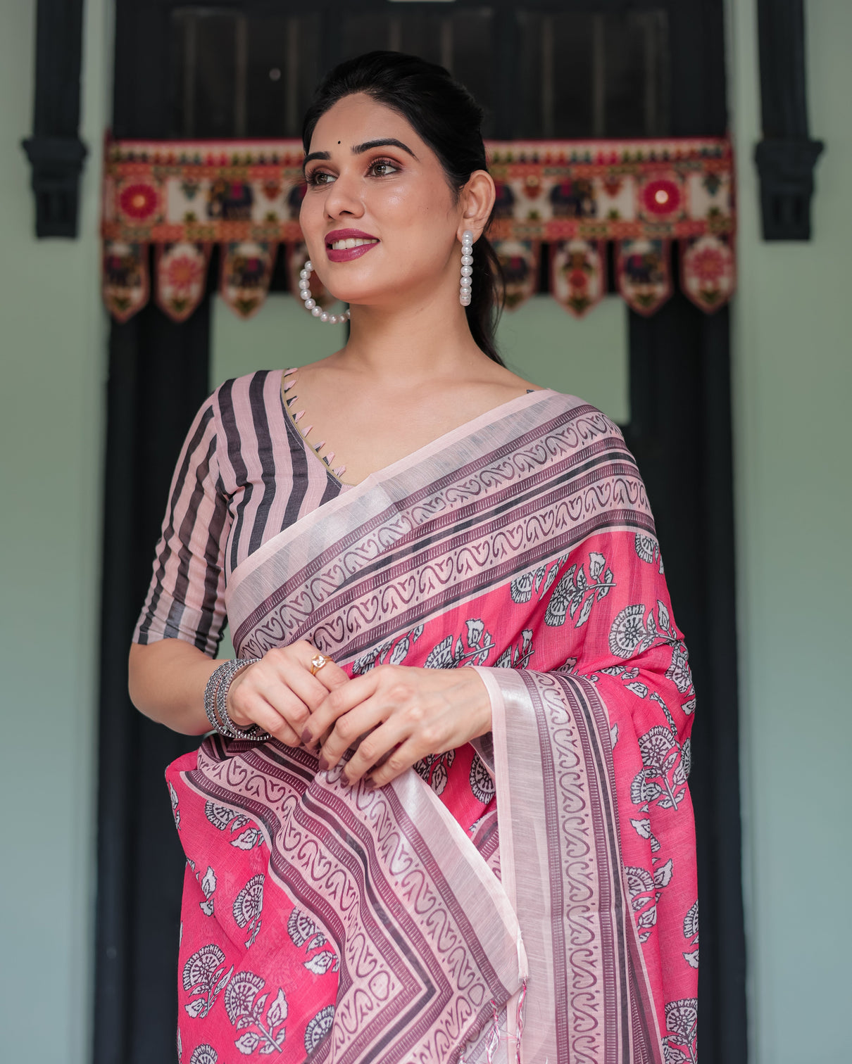 Pink and beige floral printed pure cotton linen saree with striped blouse and tassels on edges