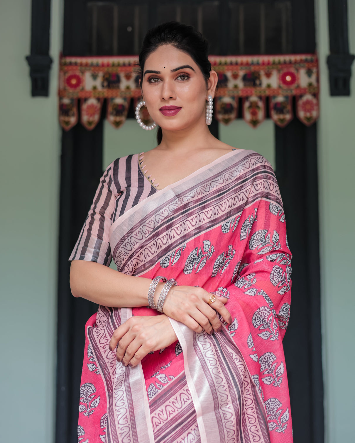 Pink and beige floral printed pure cotton linen saree with striped blouse and tassels on edges