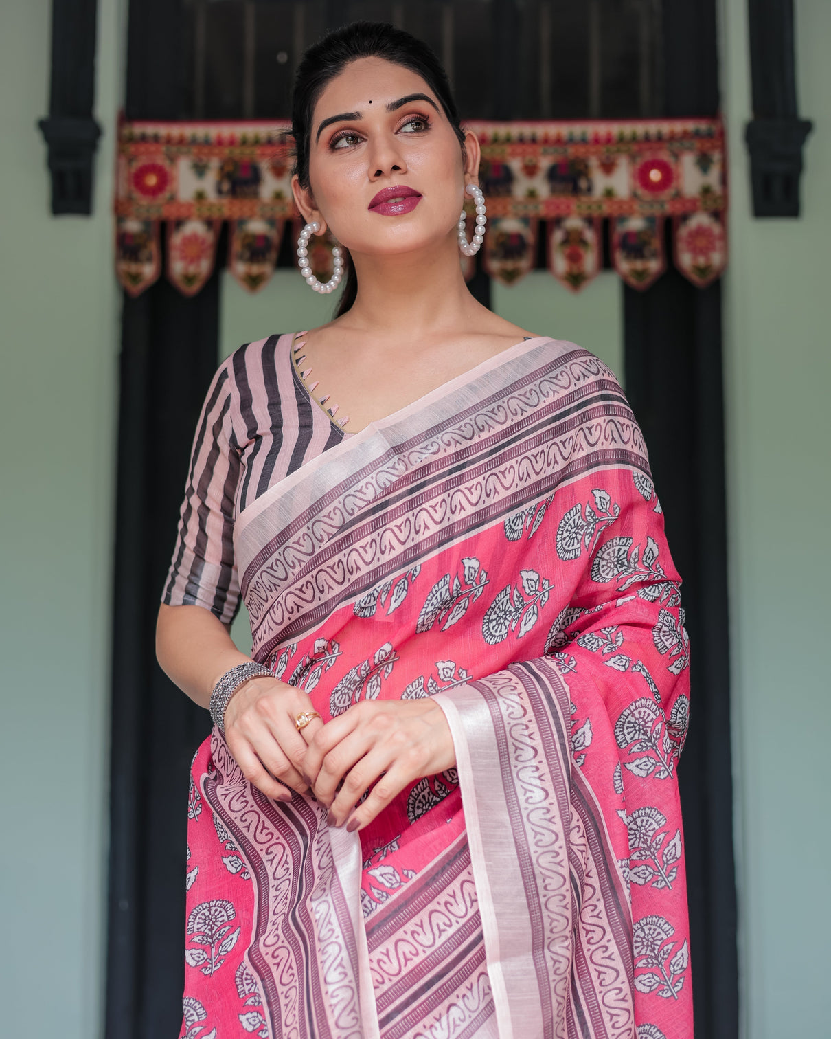 Pink and beige floral printed pure cotton linen saree with striped blouse and tassels on edges