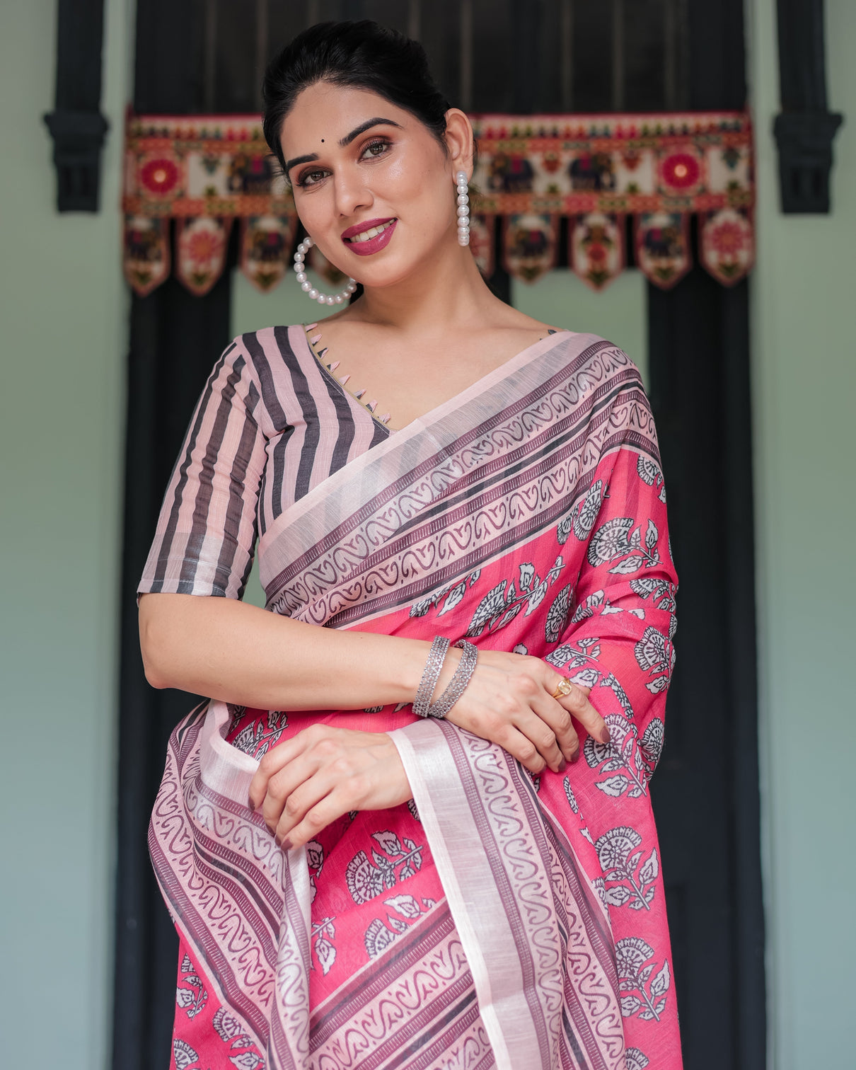 Pink and beige floral printed pure cotton linen saree with striped blouse and tassels on edges