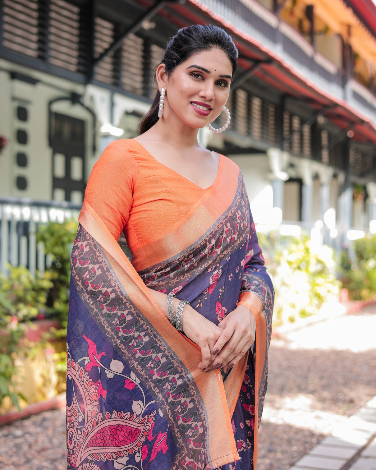 Indigo blue floral print pure cotton linen saree with orange border and tassels