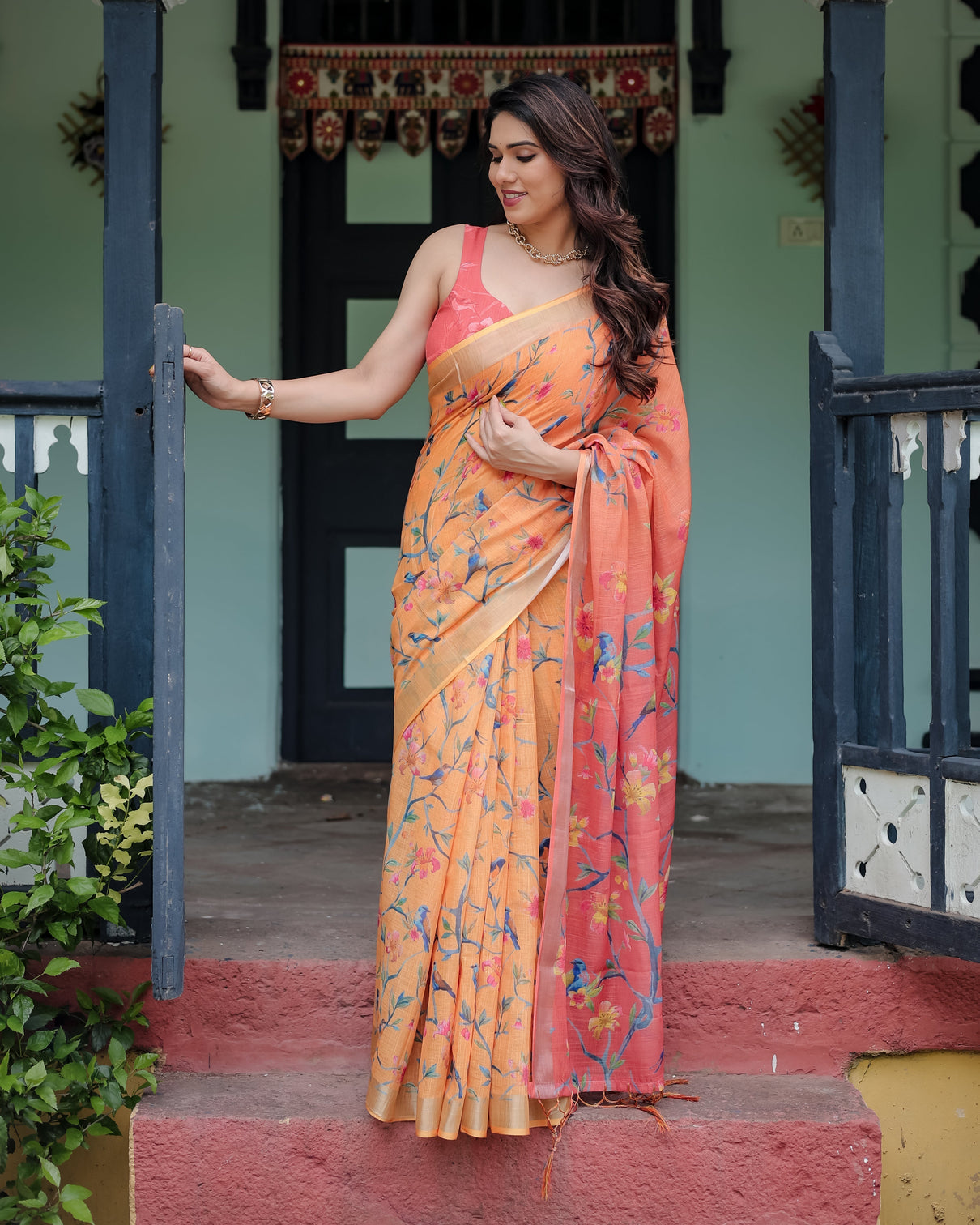 Peach and orange pure cotton linen saree with floral and bird print blouse and tassel detailing