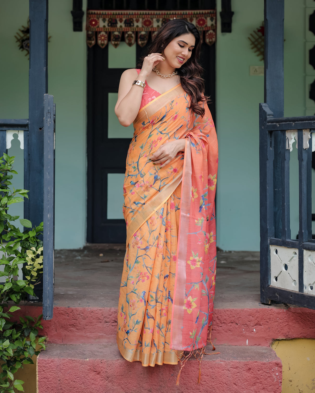 Peach and orange pure cotton linen saree with floral and bird print blouse and tassel detailing
