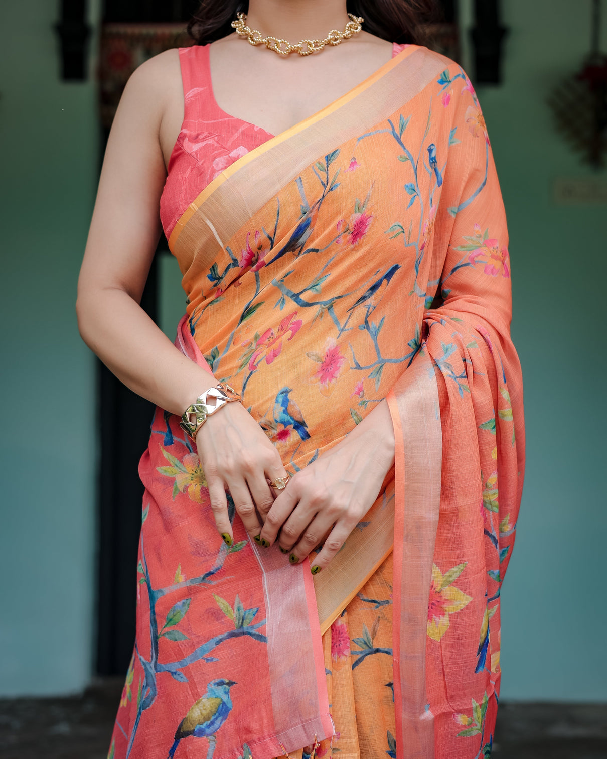 Peach and orange pure cotton linen saree with floral and bird print blouse and tassel detailing