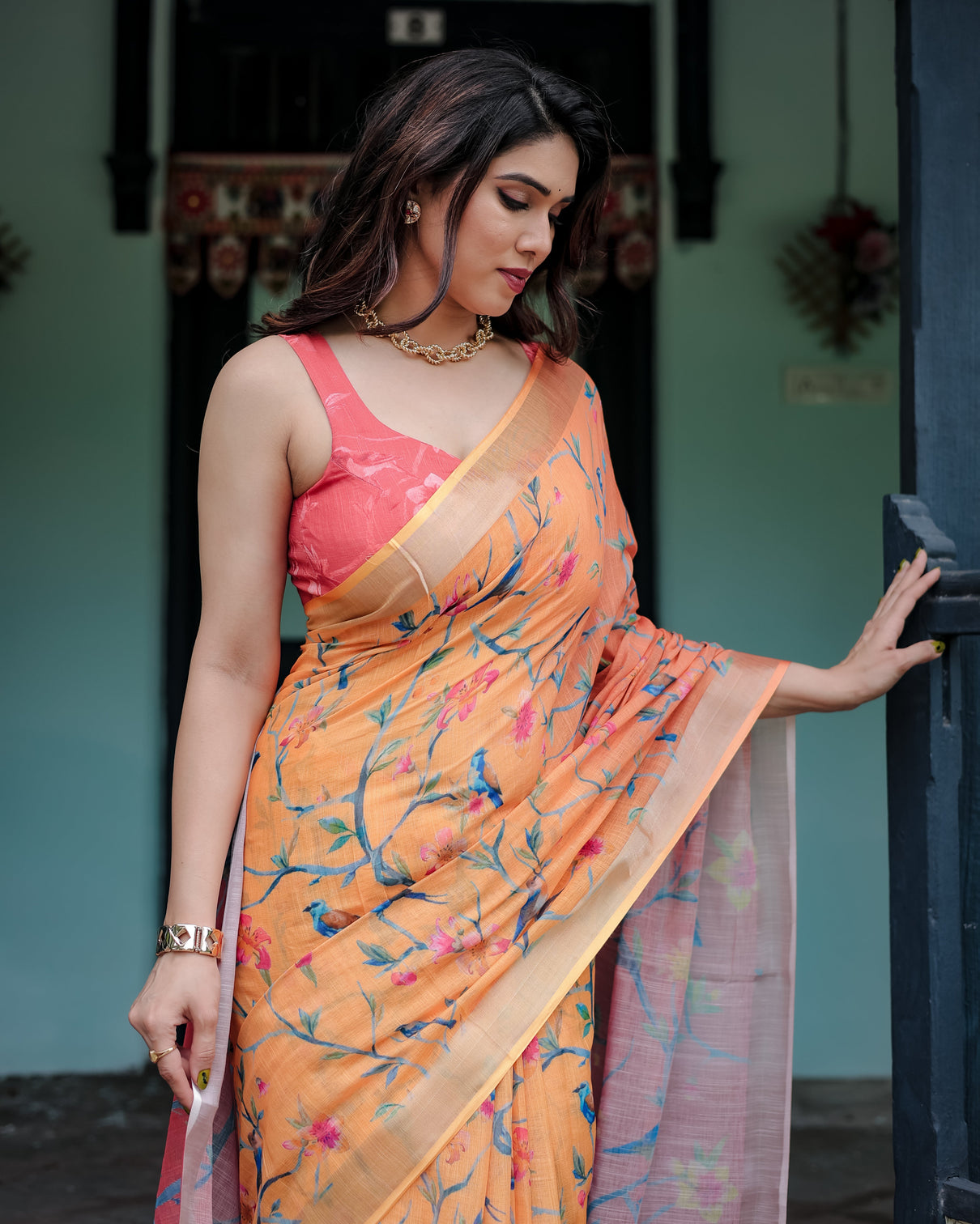 Peach and orange pure cotton linen saree with floral and bird print blouse and tassel detailing