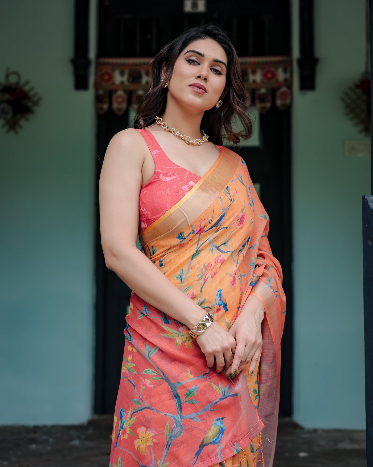 Peach and orange pure cotton linen saree with floral and bird print blouse and tassel detailing