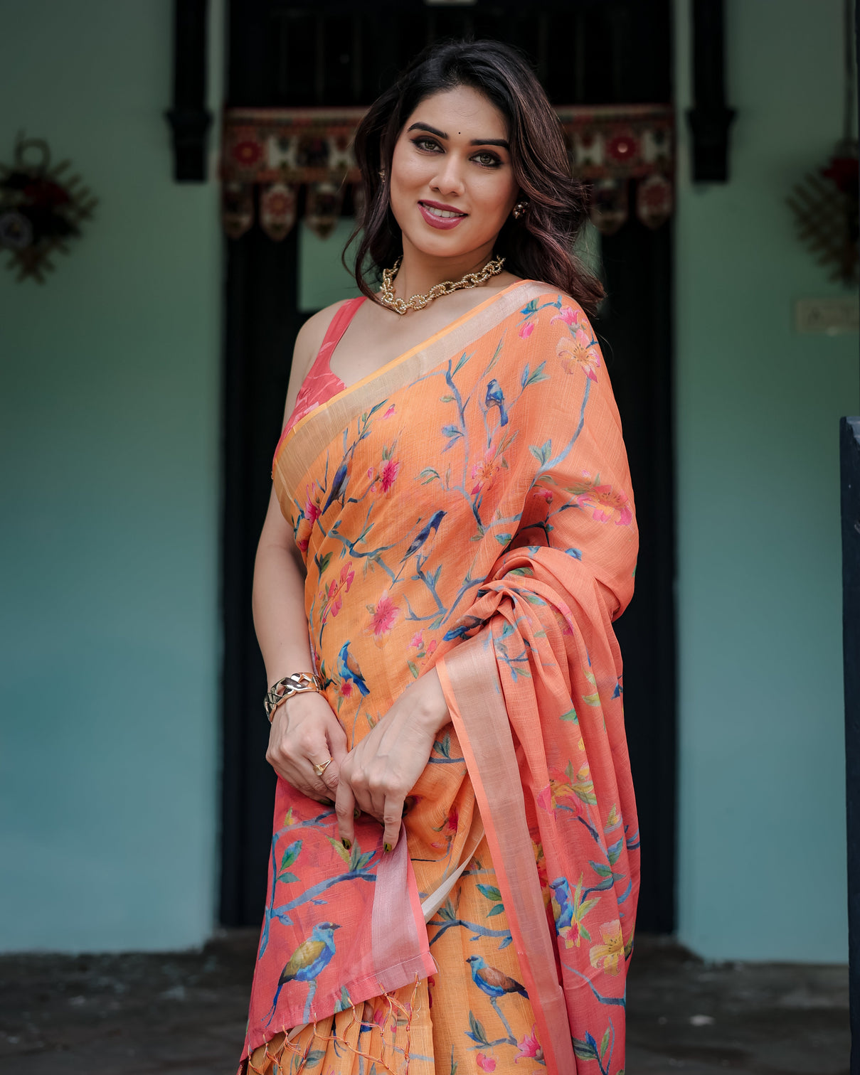 Peach and orange pure cotton linen saree with floral and bird print blouse and tassel detailing