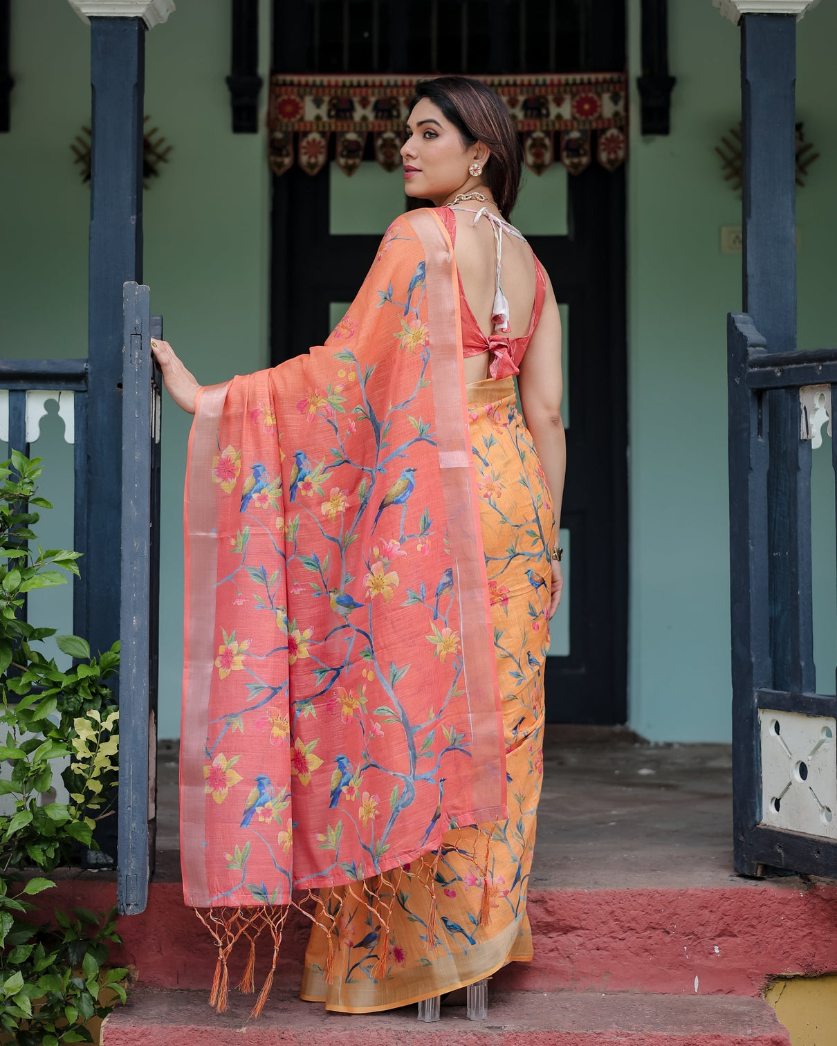 Peach and orange pure cotton linen saree with floral and bird print blouse and tassel detailing