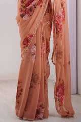 Partywear Peach Georgette Saree with Floral Prints and Bead Work Lace