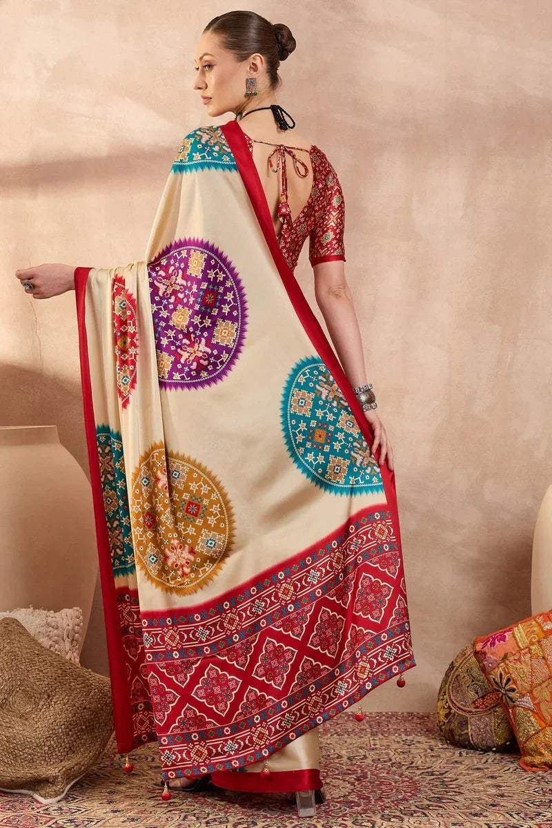 Cream modal silk saree with multicolor patola inspired print ruby red border designer festive wear saree