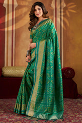 Gratifying Green Patola Silk Saree with Serendipity Blouse Piece