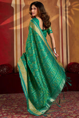 Gratifying Green Patola Silk Saree with Serendipity Blouse Piece