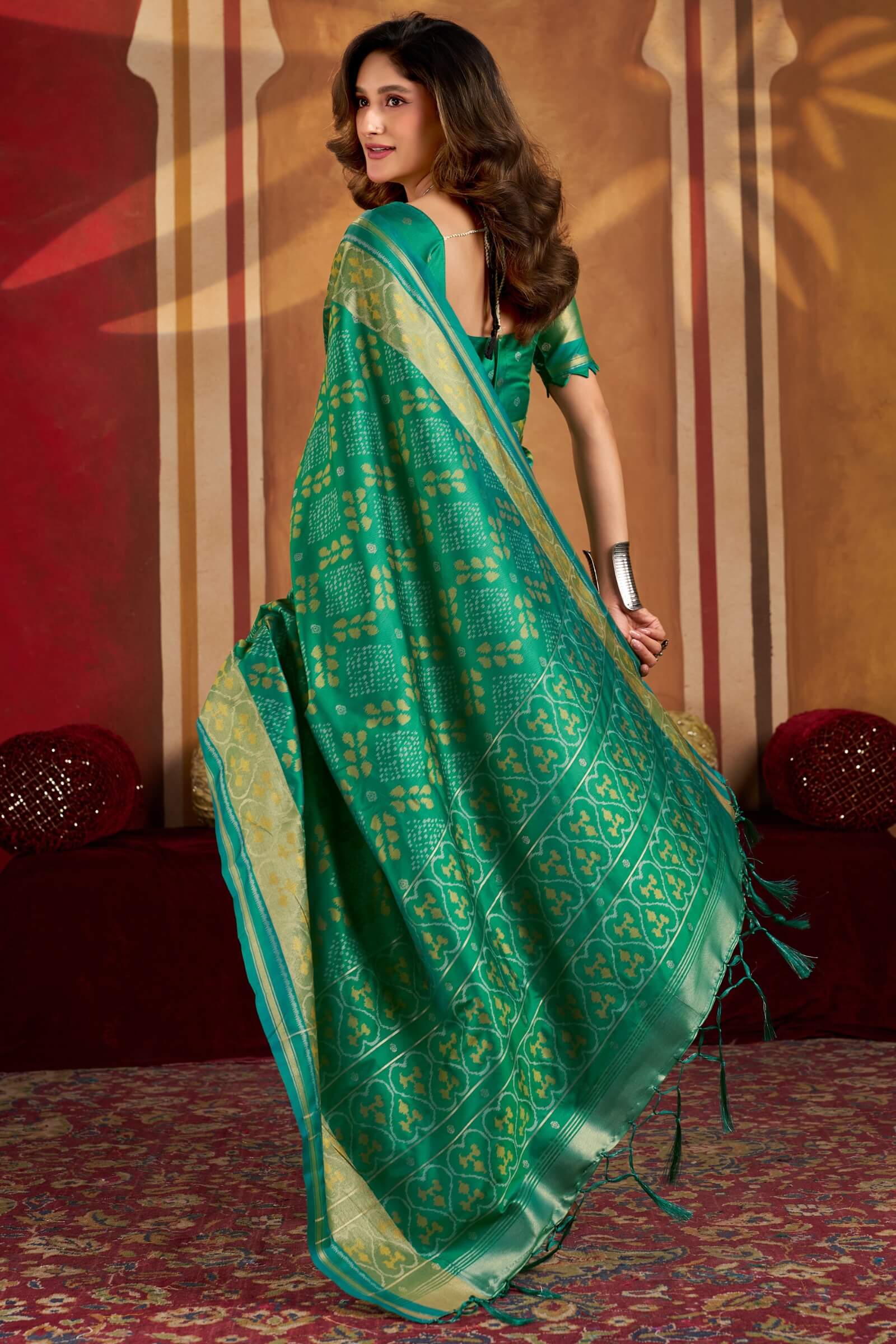 Gratifying Green Patola Silk Saree with Serendipity Blouse Piece