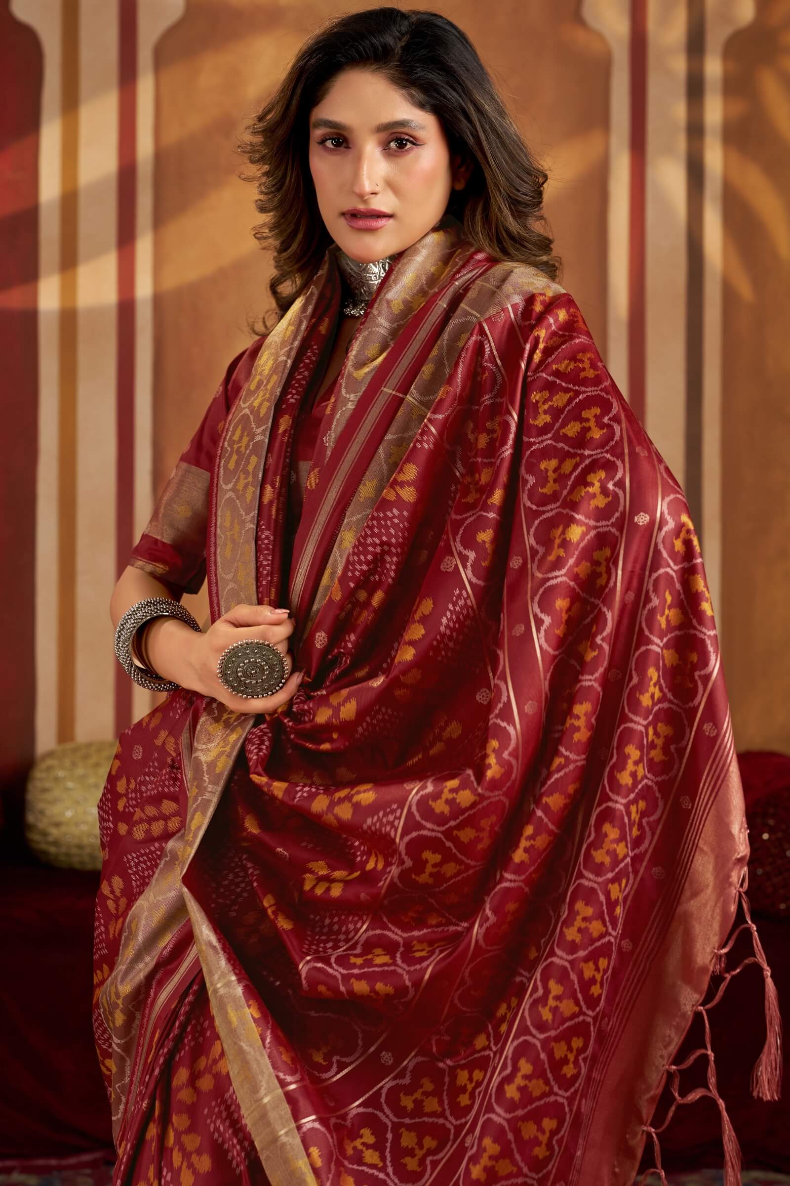 Staring Maroon Patola Silk Saree with Precious Blouse Piece