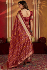 Staring Maroon Patola Silk Saree with Precious Blouse Piece
