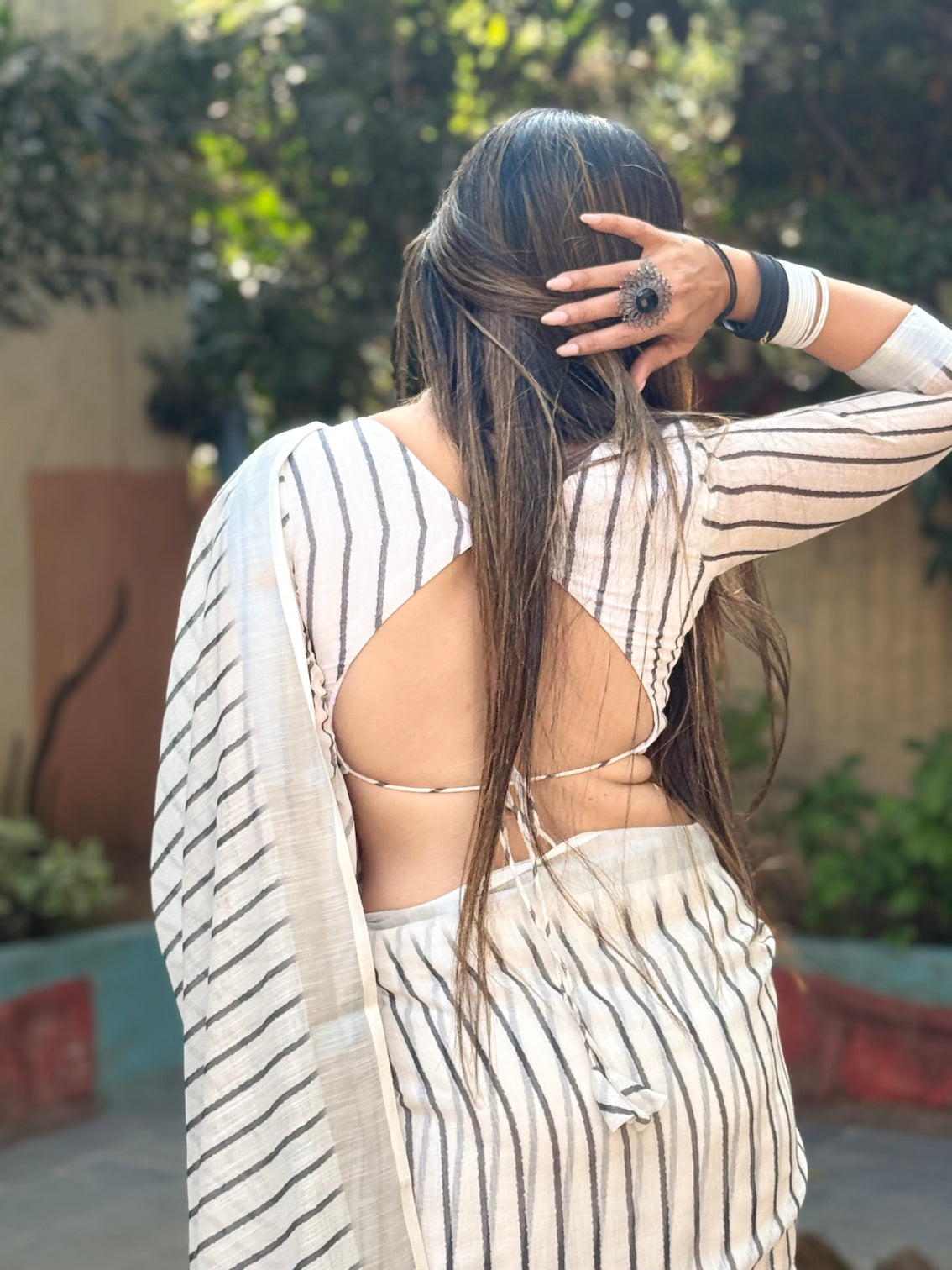 Elegant off white pure linen digital printed saree with striped design and unique black motif pallu comes with blouse piece and tassels