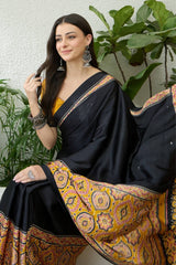 Jubilant Black Ajrakh Printed Semi Modal Silk Saree With Surpassing Blouse Piece