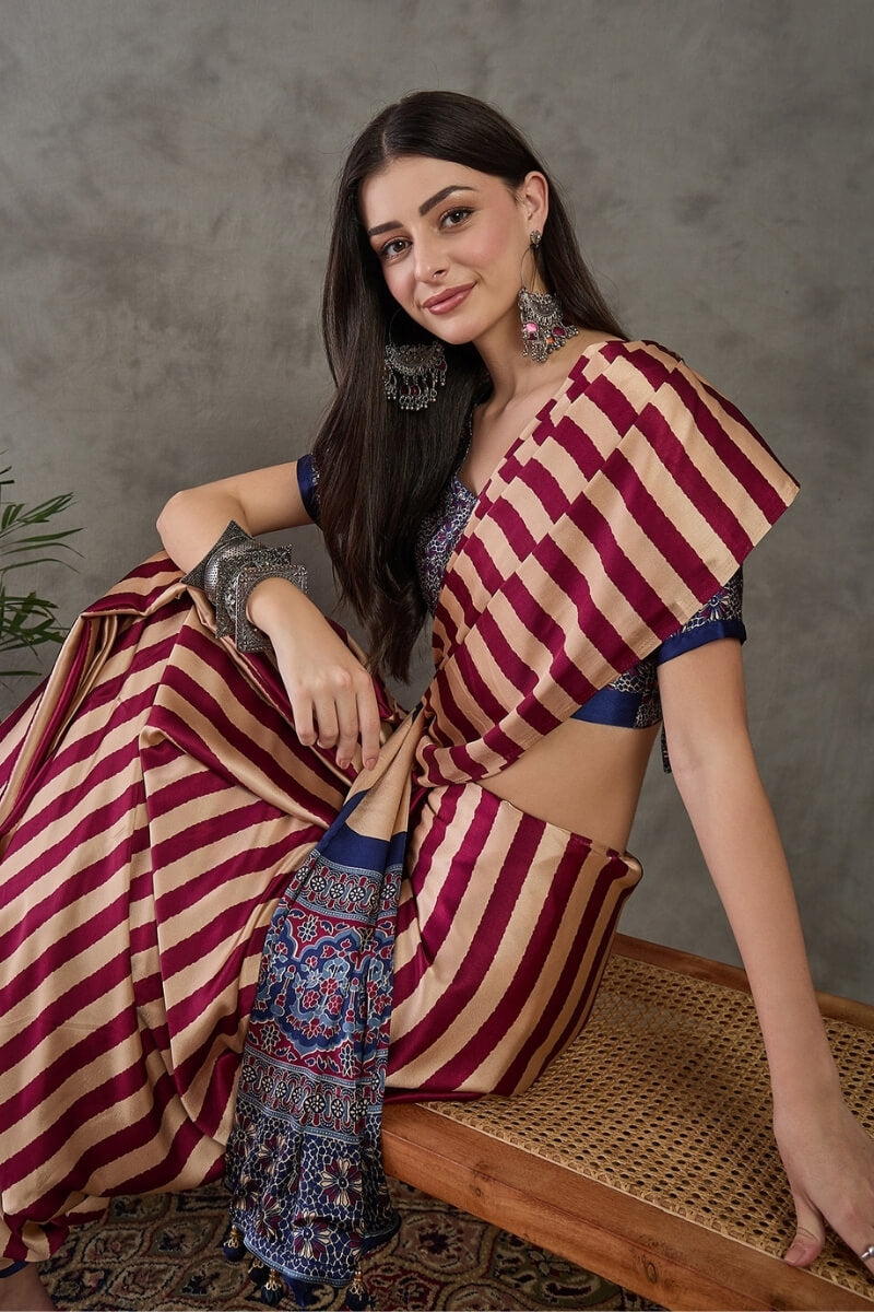 Prominent Maroon Ajrakh Printed Semi Modal Silk Saree With Engaging Blouse Piece