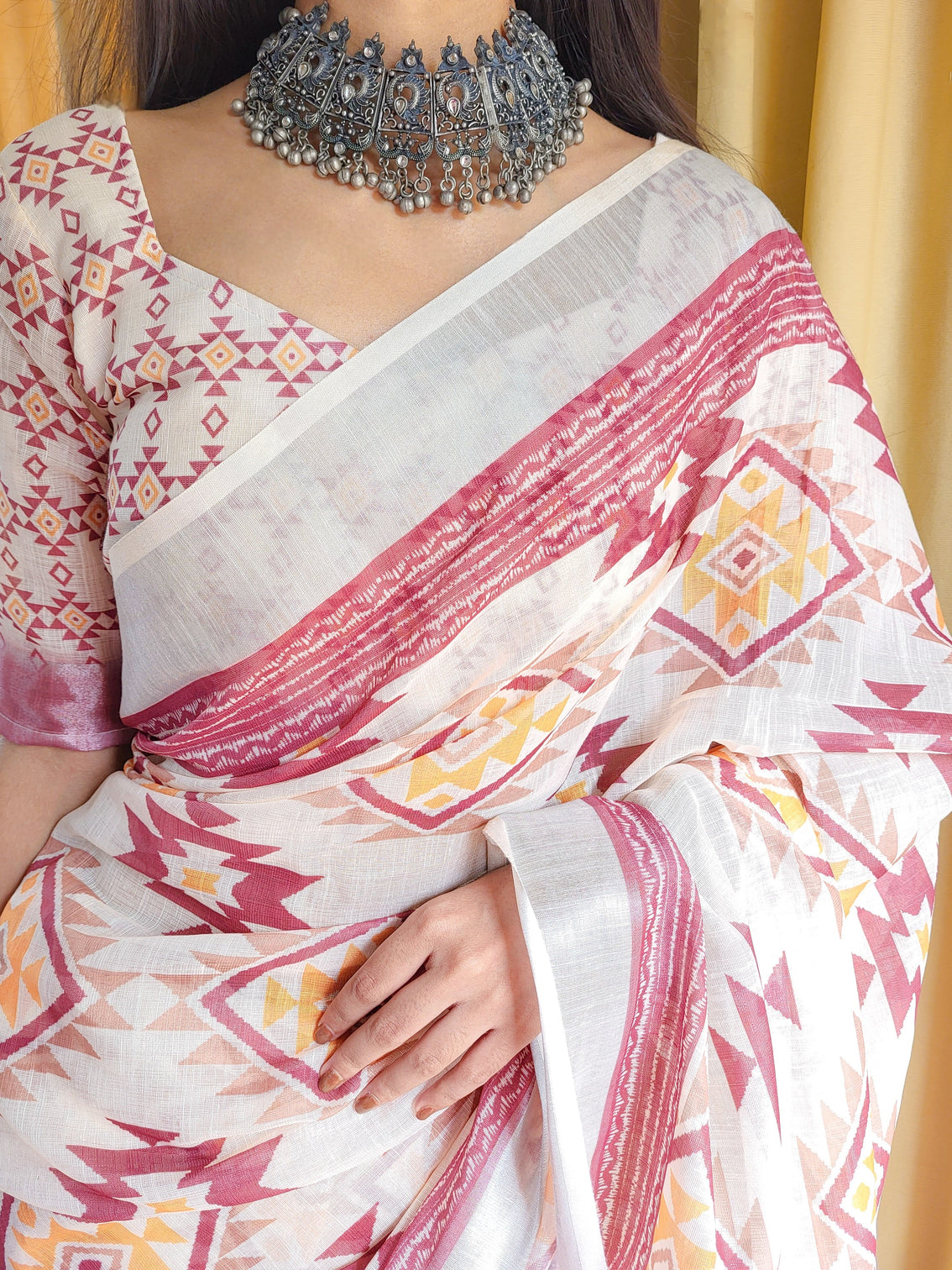 Ivory linen saree with geometric tribal prints tassel accents