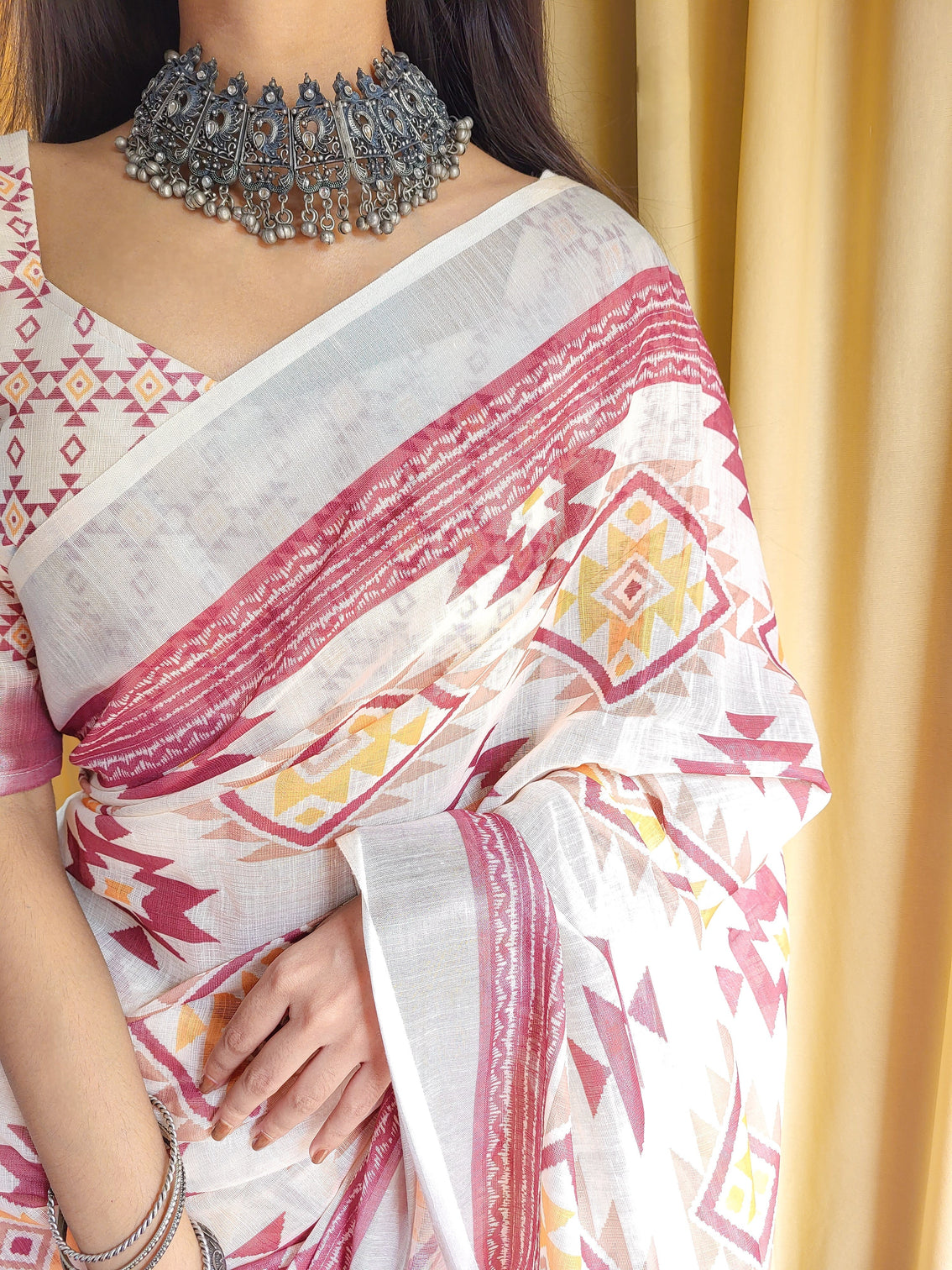 Ivory linen saree with geometric tribal prints tassel accents