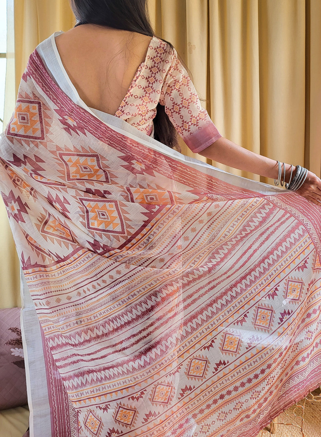 Ivory linen saree with geometric tribal prints tassel accents