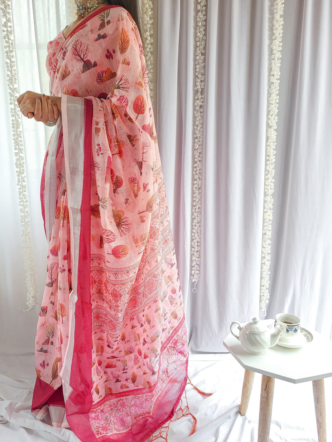 Blush pink handwoven linen saree with vibrant autumn motifs tassel detailing