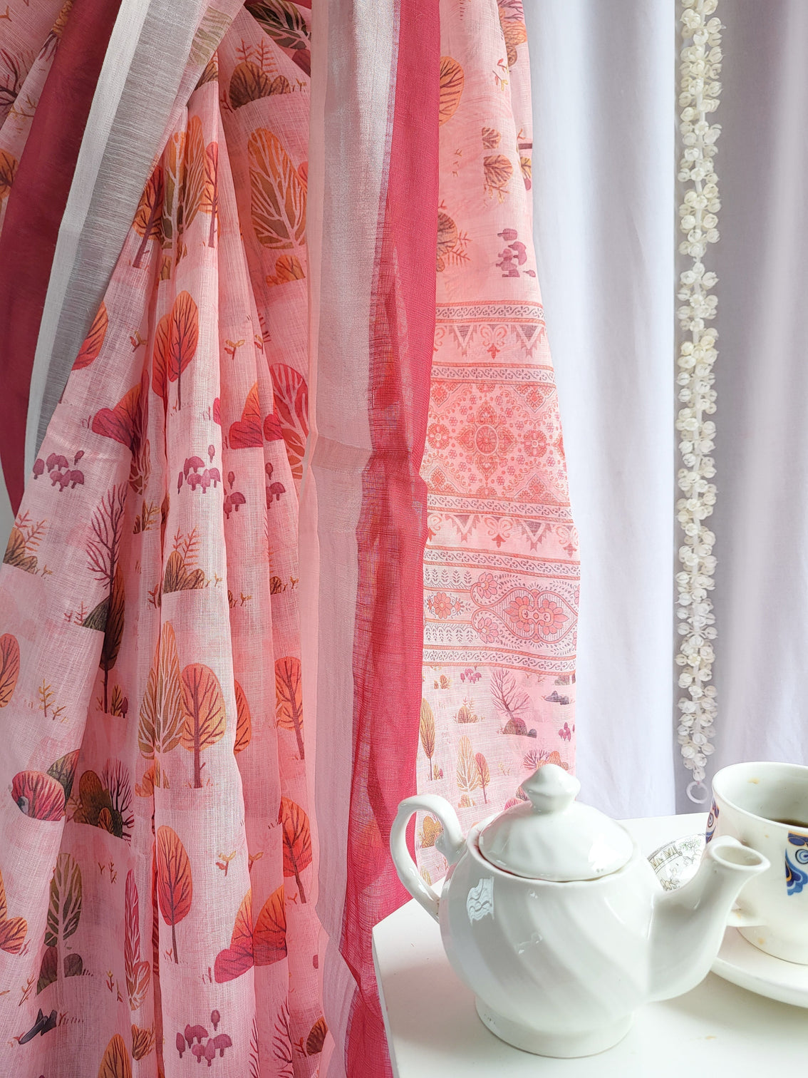 Blush pink handwoven linen saree with vibrant autumn motifs tassel detailing