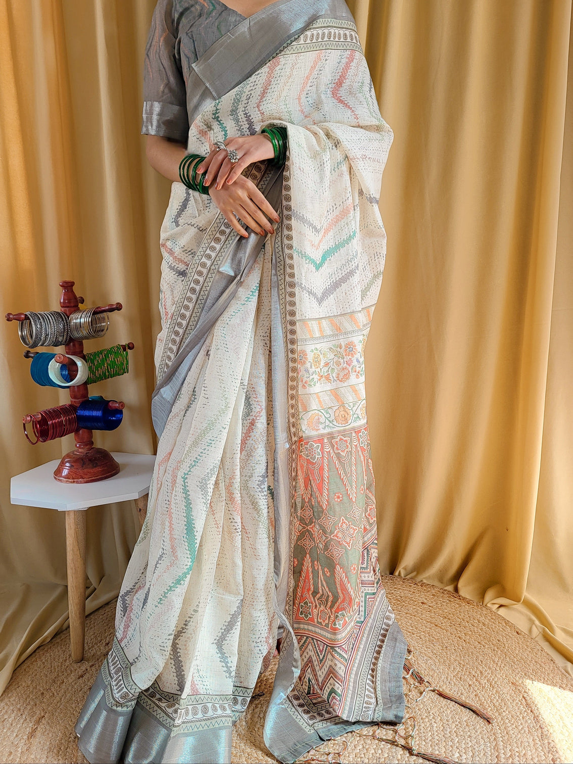 Elegant beige pure linen saree with multicolor zigzag design and tassel finish
