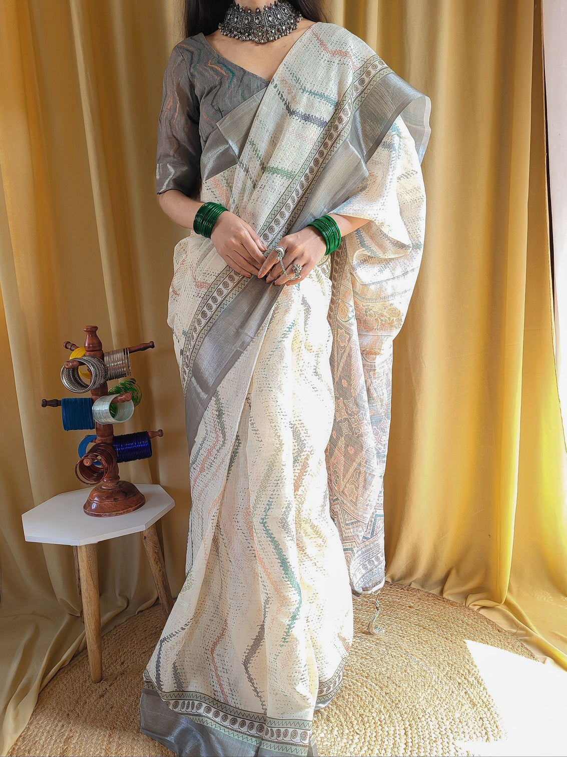 Elegant beige pure linen saree with multicolor zigzag design and tassel finish