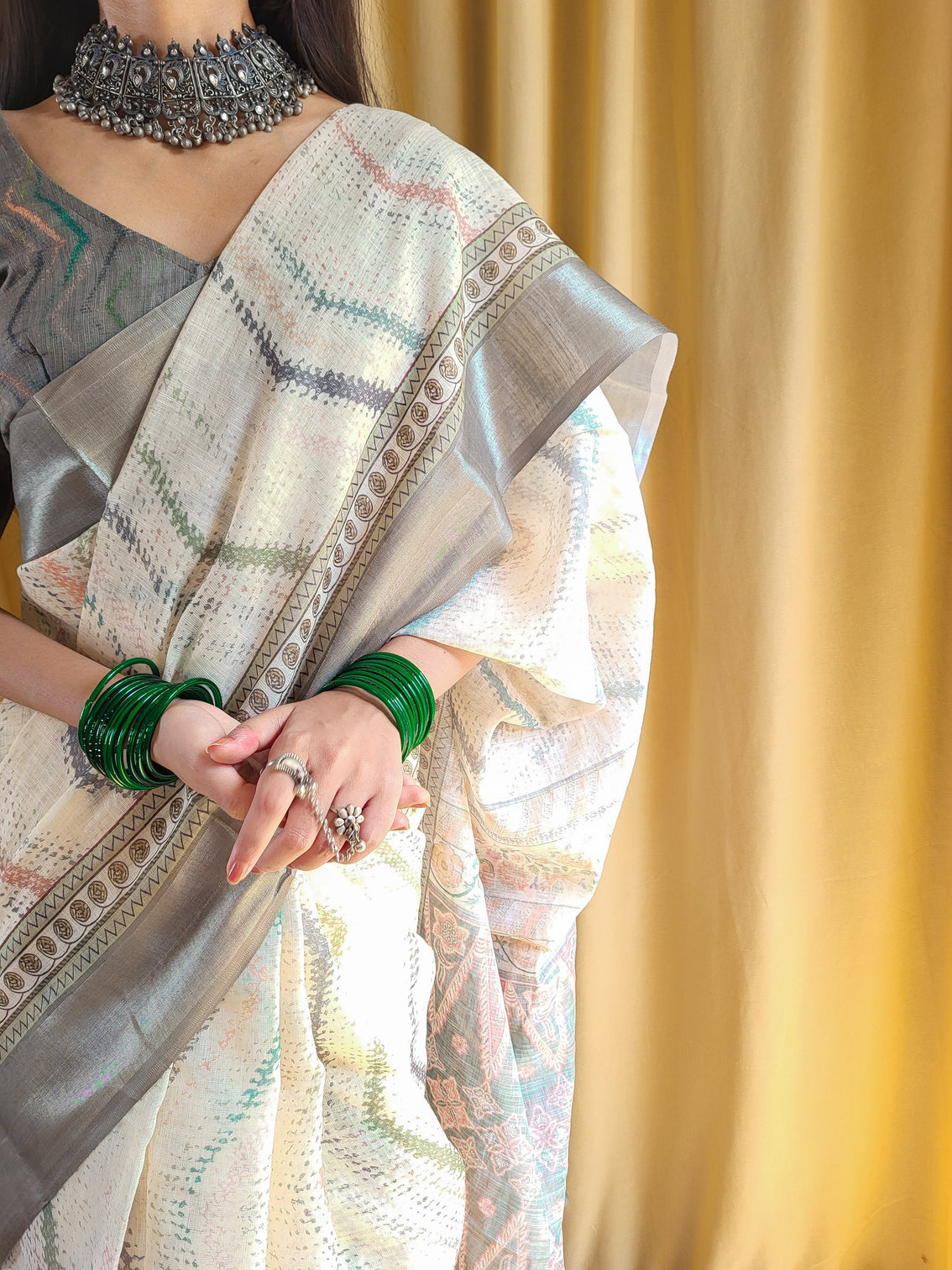 Elegant beige pure linen saree with multicolor zigzag design and tassel finish