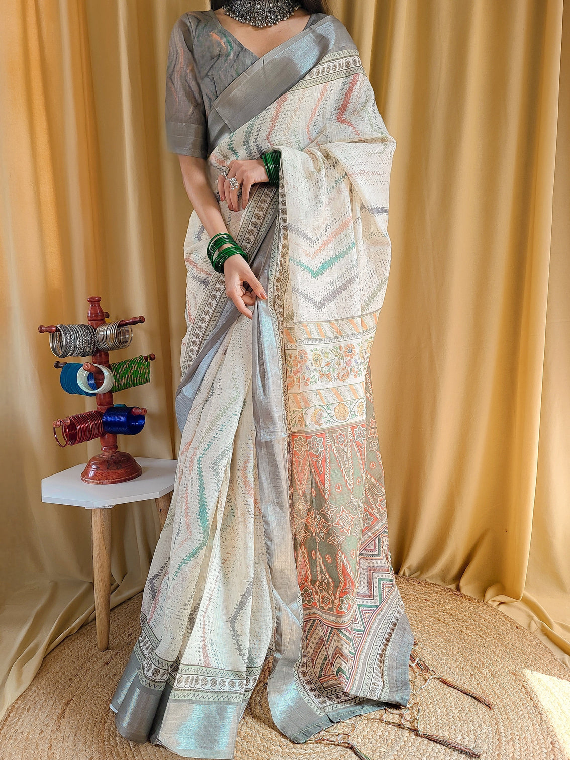 Elegant beige pure linen saree with multicolor zigzag design and tassel finish