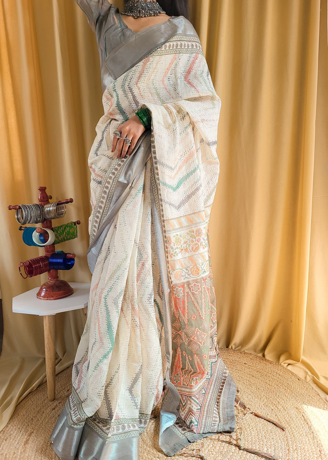 Elegant beige pure linen saree with multicolor zigzag design and tassel finish