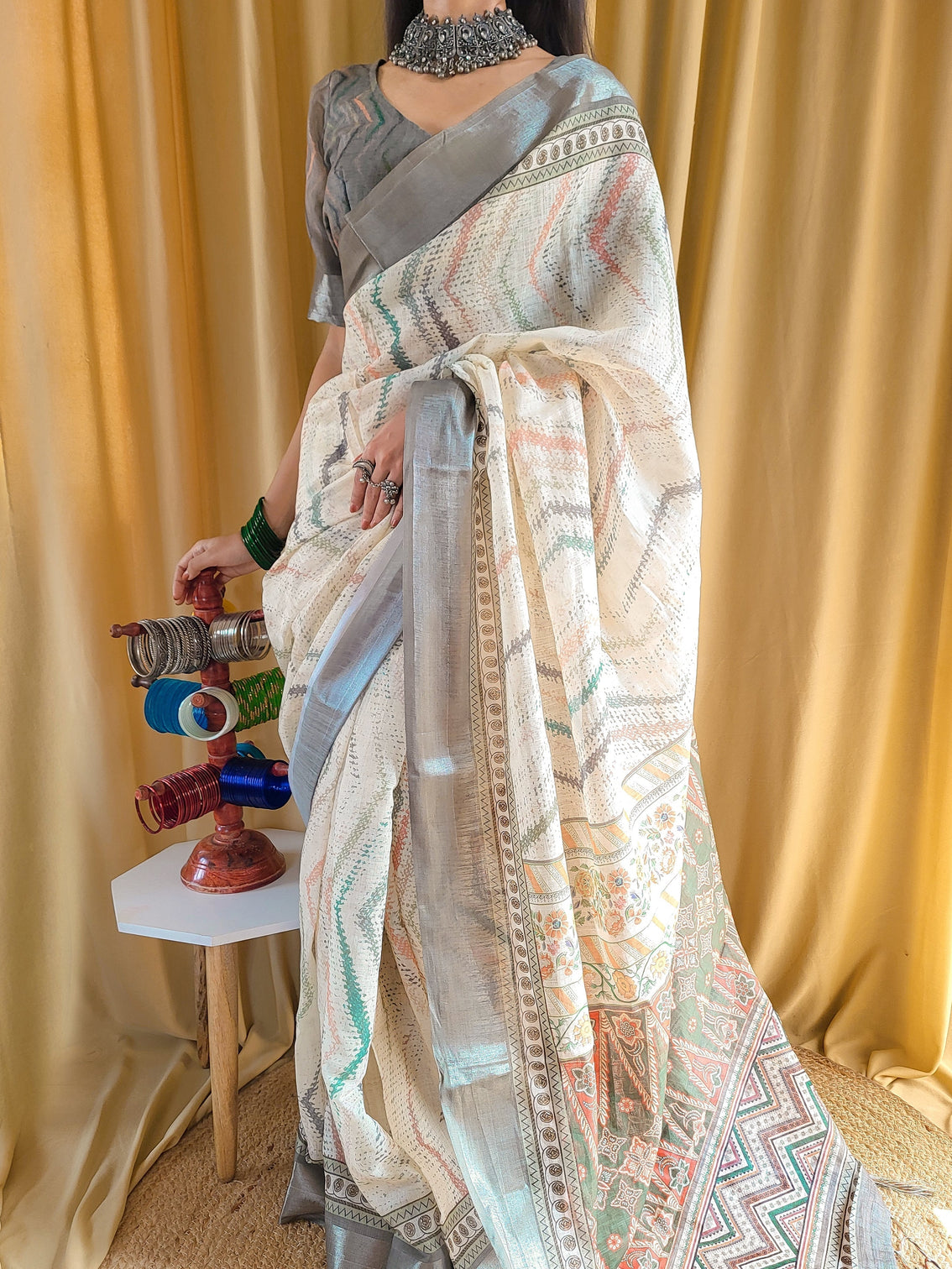 Elegant beige pure linen saree with multicolor zigzag design and tassel finish mameraa