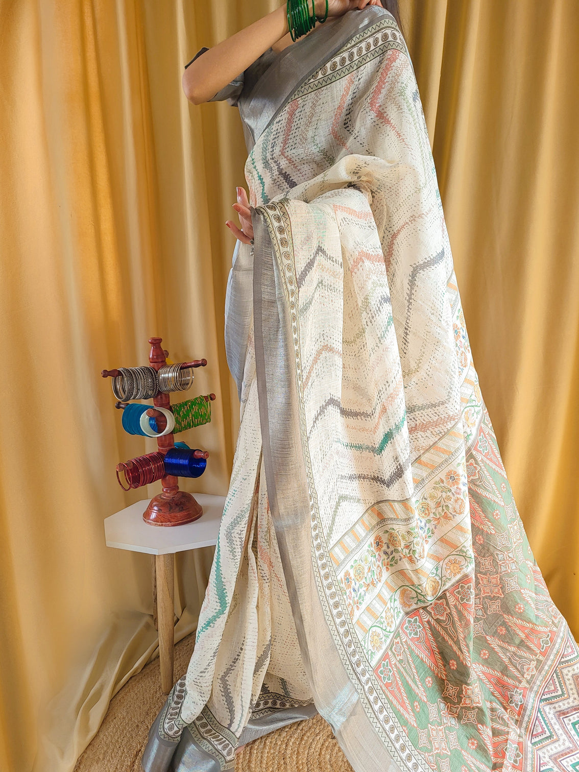 Elegant beige pure linen saree with multicolor zigzag design and tassel finish