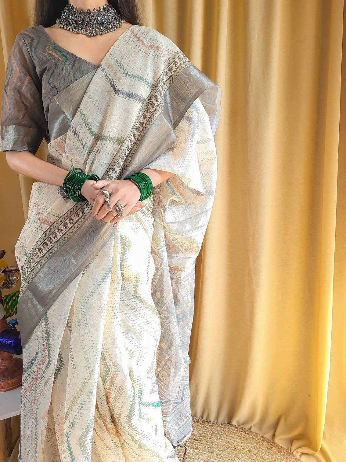 Elegant beige pure linen saree with multicolor zigzag design and tassel finish