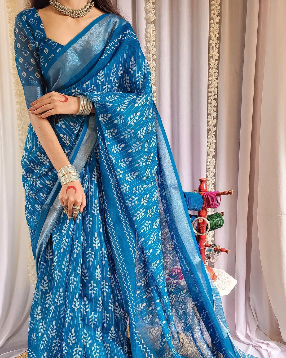 Elegant blue pure linen saree with tassels and white floral patterns