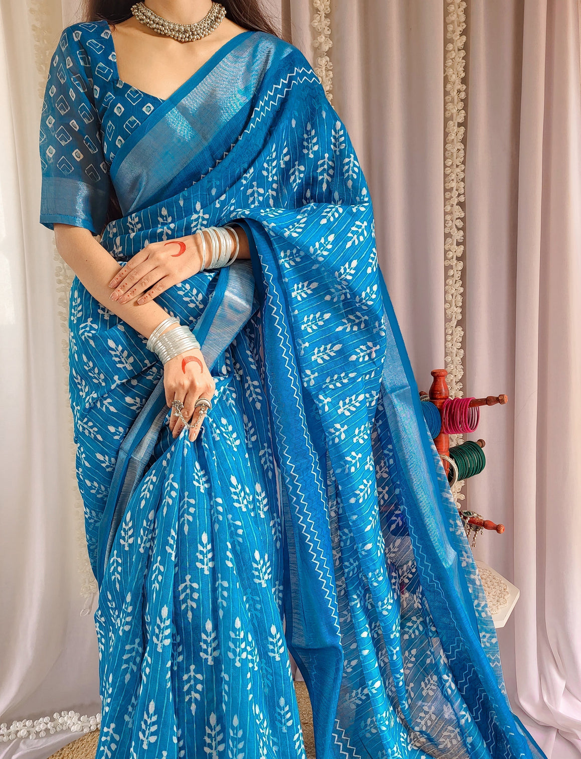 Elegant blue pure linen saree with tassels and white floral patterns