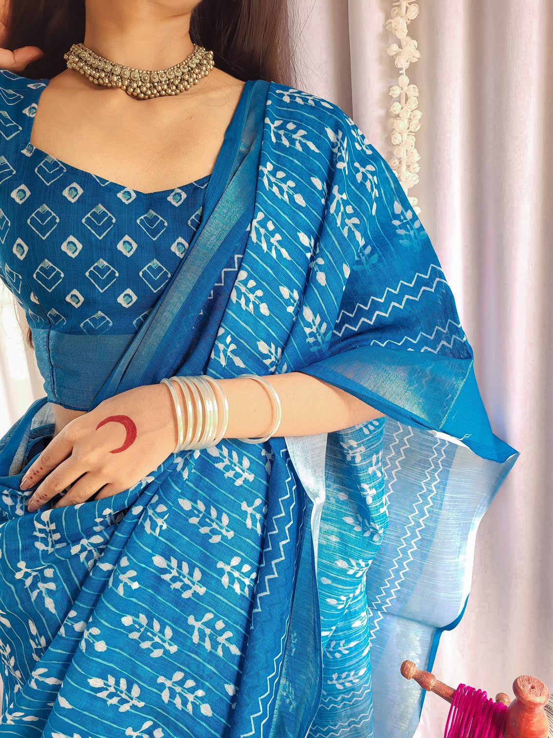 Elegant blue pure linen saree with tassels and white floral patterns