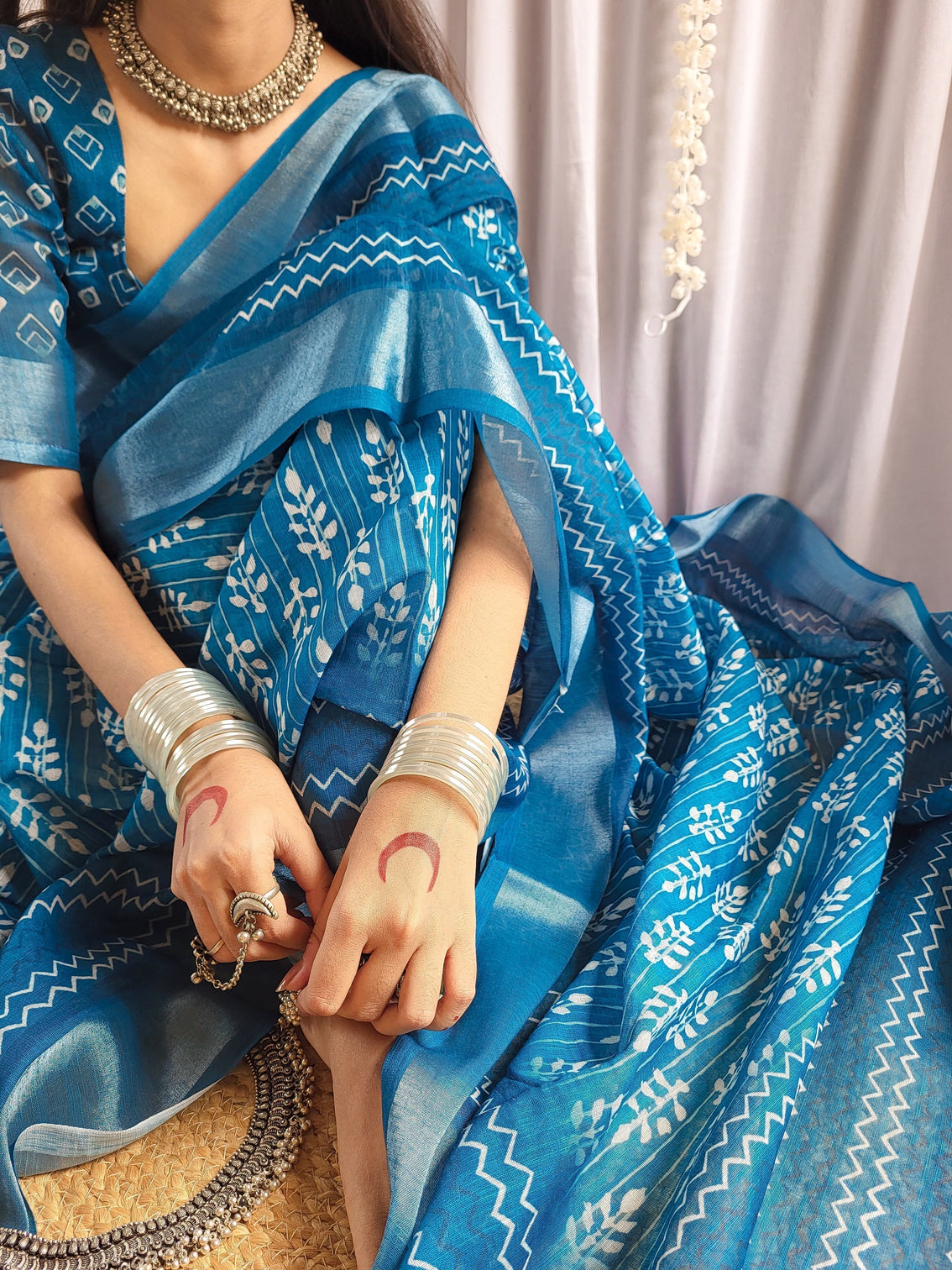 Elegant blue pure linen saree with tassels and white floral patterns