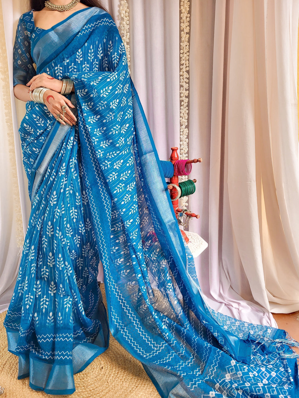 Elegant blue pure linen saree with tassels and white floral patterns